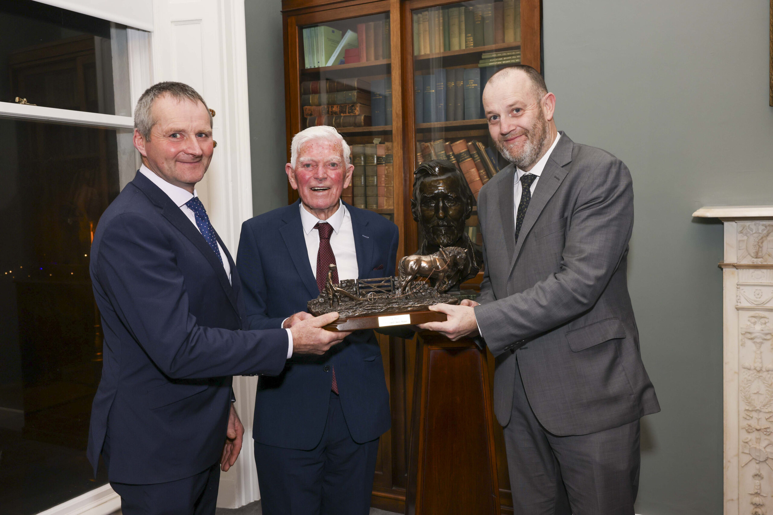 Ted Hunt receives the Plunkett Award from Edward Carr, President of the Irish Co-operative Organisation Society (ICOS) and CEO TJ Flanagan (on right).